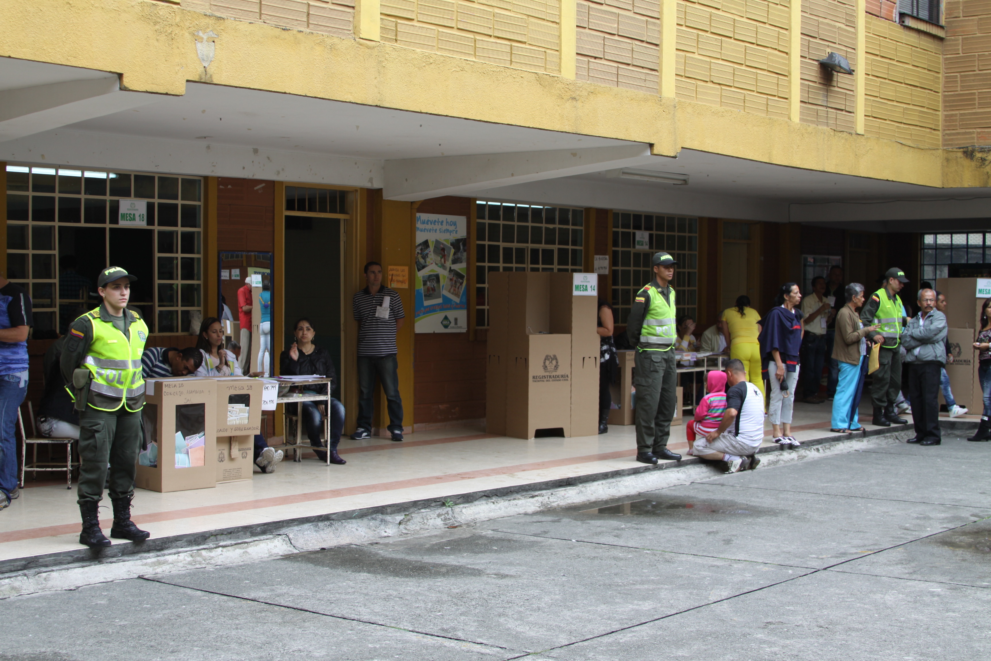 Colombian police stand guard outside a voting station.